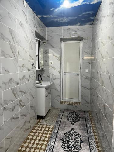 a white bathroom with a sink and a shower at Jumgal Nomad Nest in Kyzart