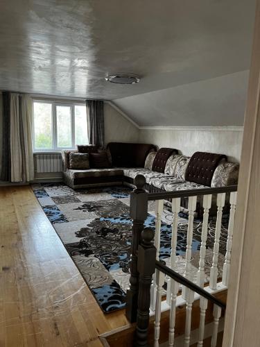 a living room with a couch and a rug at Jumgal Nomad Nest in Kyzart