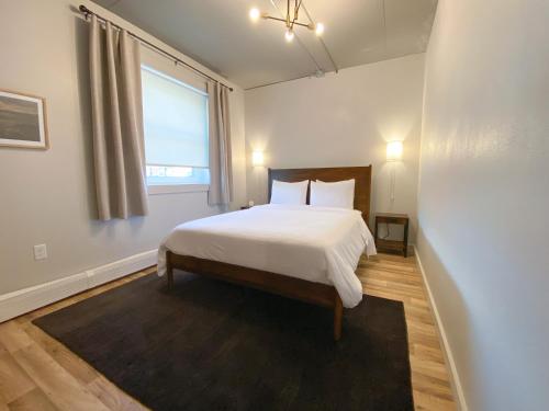 a bedroom with a white bed and a window at Ingalls Flat in De Smet