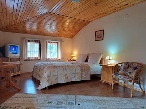 a bedroom with a bed and a wooden ceiling at Guest House Benita in Devin