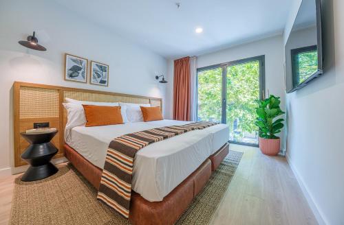 a bedroom with a large bed and a large window at Aduana Suites in Salou