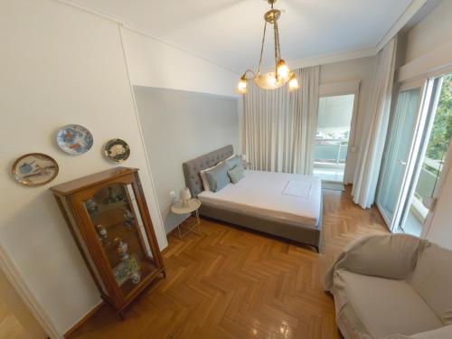 a bedroom with a bed and a couch in a room at Central Family Flat Volos in Volos