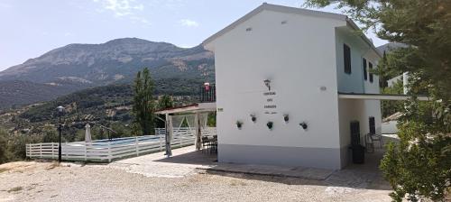 a white building with a mountain in the background at Los Cabales in Torres