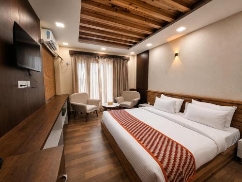 a hotel room with a bed and a television at Kanyam Brichyalaya in Suryodaya