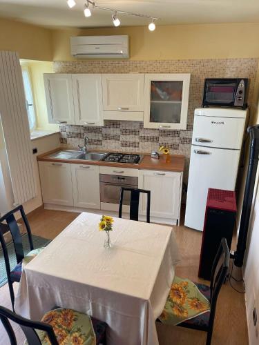 a kitchen with a table with a vase of flowers on it at B&b DA FELICE MONOLOCALE in Serino