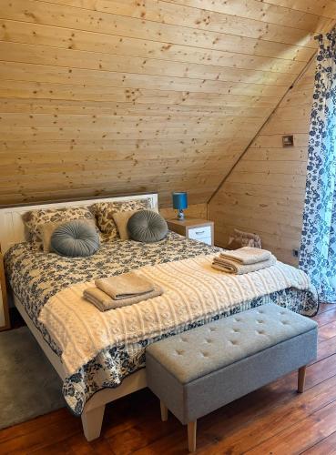 a bedroom with a bed and a wooden wall at Leonówka in Jegliniec
