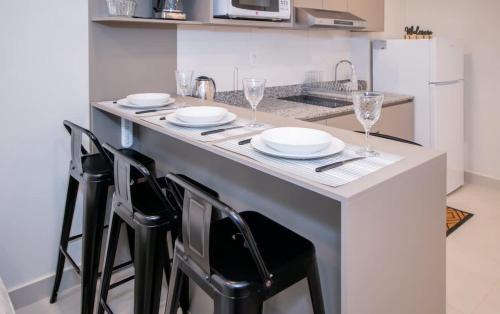 a kitchen with a table with plates and glasses on it at Peaceful Stay with Rooftop Pool Access in Fernando de la Mora