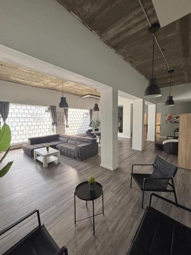 a living room with two couches and a table at Loft character in Eggenstein-Leopoldshafen