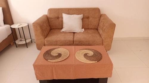 a living room with a couch and a coffee table at Izuba in Ngaparou