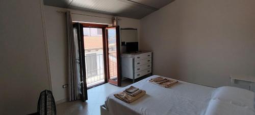 a bedroom with a bed and a dresser and a window at House biase e marrys in Trecchina