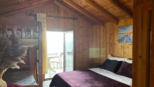 a bedroom with a bed in a wooden room at Hotel Brigeni & Camping Riviera in Shëngjin