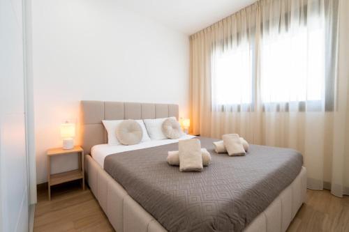 a bedroom with a large bed with two pillows on it at Casa juley in Torrevieja