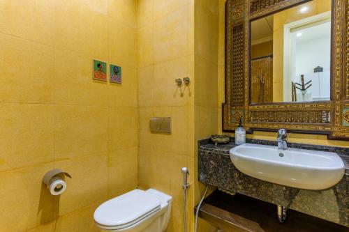 a bathroom with a sink and a toilet and a mirror at Convivium 5 - High-end Studio in Gemmayze in Beirut