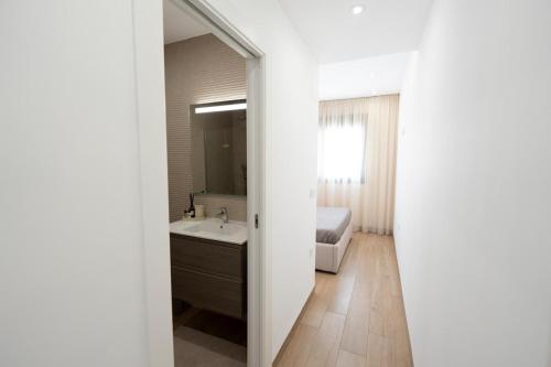 a bathroom with a sink and a bed and a mirror at Casa juley in Torrevieja
