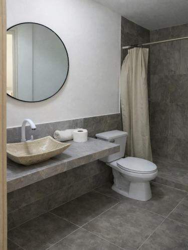 a bathroom with a sink and a toilet and a mirror at Casa Tania playa larga in Agua de Correa