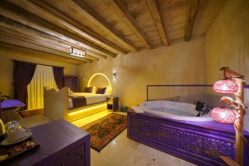 a large bathroom with a tub and a bed at Üçhisar Palace İn Cappadocia in Uçhisar