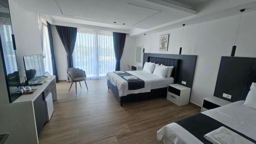a hotel room with a bed and a television at AnDora in Donji Štoj