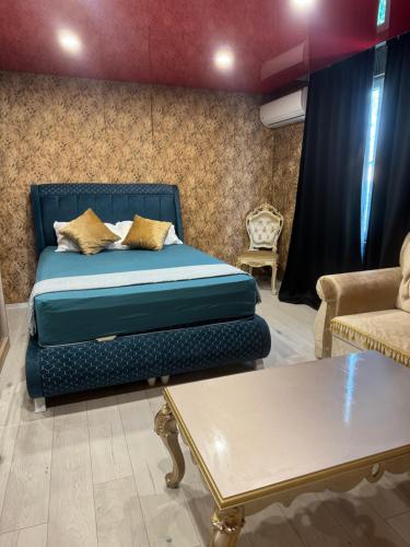 a bedroom with a bed and a couch and a table at Arolen in Nesebar