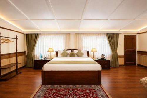 a bedroom with a large bed and two night stands at Springfields - A Heritage Palace Since 1902 by Eastlynn Experiences in Shimla