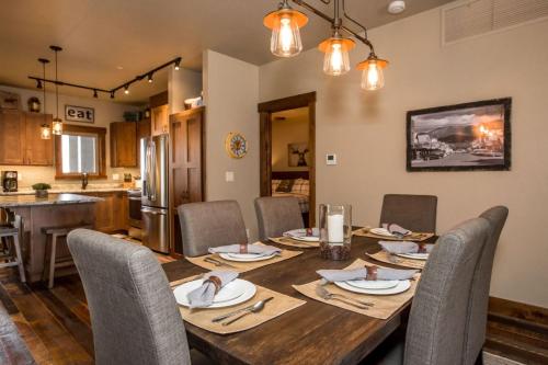 a dining room with a wooden table and chairs at Baker Loft 203 in Whitefish