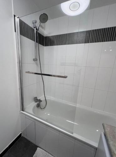 a bathroom with a bath tub with a shower at La Maison Cocoon in Étampes