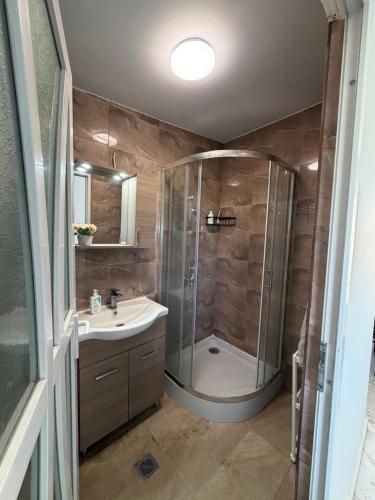 a bathroom with a shower and a sink at Sea view Kastri in Nei Poroi