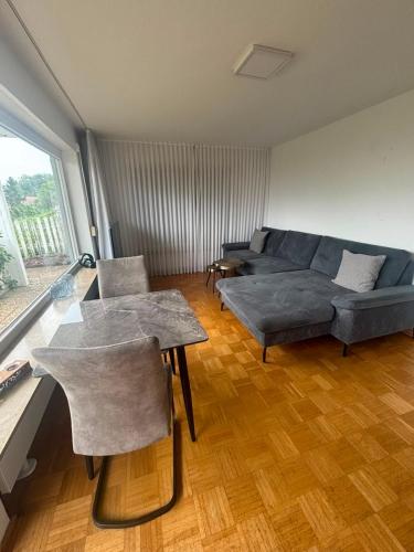 a living room with a couch and a table at Ferienunterkunft International A in Bad Harzburg