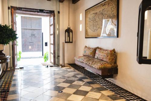 a living room with a couch on a tiled floor at Hotel Boutique Casa del Coliseo in Cartagena de Indias
