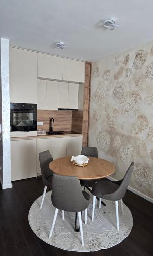 a kitchen with a wooden table and chairs at Stan apartman Kolašin in Kolašin
