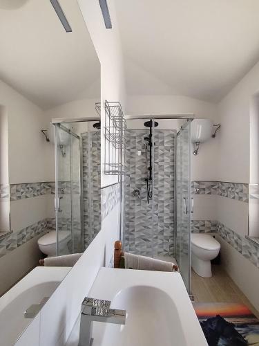 a bathroom with two sinks and a shower at Maison di Mario in Tresnuraghes