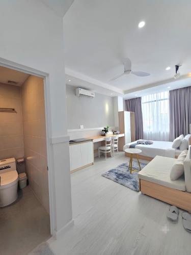 a room with a bed and a kitchen and a living room at 1001 Stars Hotel in Ho Chi Minh City