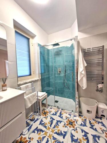 a bathroom with a shower with a glass door at Sea View MdG in Marina di Gioiosa Ionica