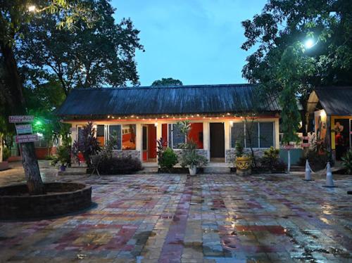 a house with a stone courtyard in front of it at SHANKARDHABA&resort in Guwahati