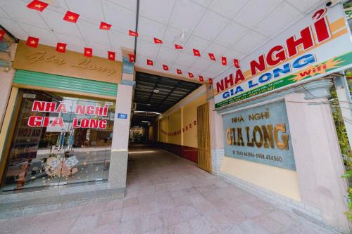 a hallway of a mall with signs on the walls at Gia Long Motel in Long Hai