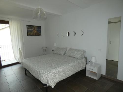 a bedroom with a bed in a white room at Ca' Fontanetta Holiday Home in Caprie