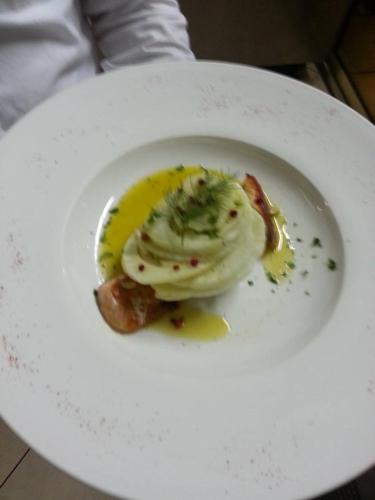 a white plate with a piece of food on it at Hotel Mustang in Tirana