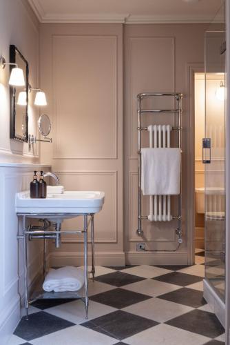 a bathroom with a sink and a shower at Dumbleton Hall in Broadway
