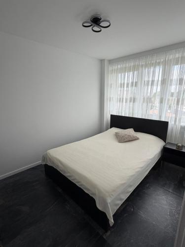 a bedroom with a bed with a ceiling fan at Silver II in Świnoujście