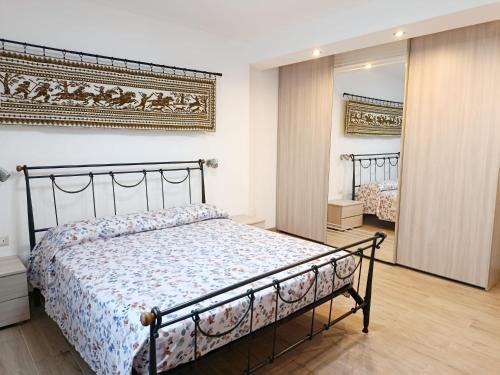 a bedroom with a bed and a mirror at Casa IS JANAS in San Sperate