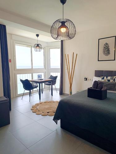 a bedroom with a bed and a table and chairs at BEACH ALMIRANTE 9 MIJAS Marbella in Sitio de Calahonda