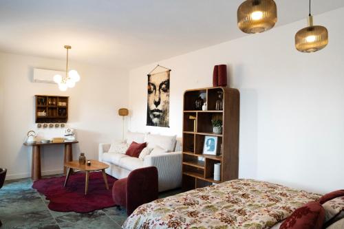 a living room with a bed and a couch at Horizon Carcassonne in Carcassonne