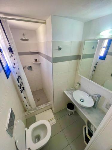 a bathroom with a toilet and a sink at Villa Nefeli in Perissa