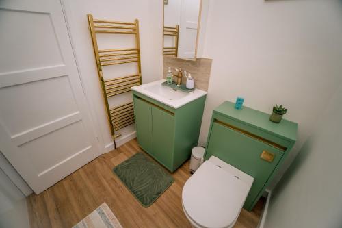 a small bathroom with a toilet and a sink at Avalonia in Glastonbury