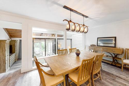 a dining room with a wooden table and chairs at Twin Oaks 207 in Hilton Head Island