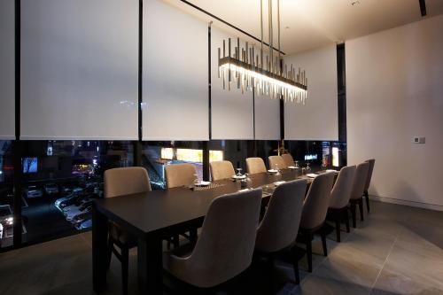 a dining room with a long table and chairs at Hotel Entra Gangnam in Seoul