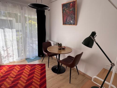 a room with a table and chairs and a lamp at Villa Auguste chambres d'hôtes in Quimper