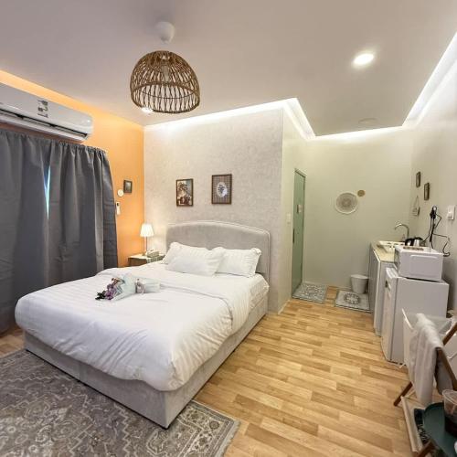 a bedroom with a large white bed in a room at The Italian Studio3 in Dammam