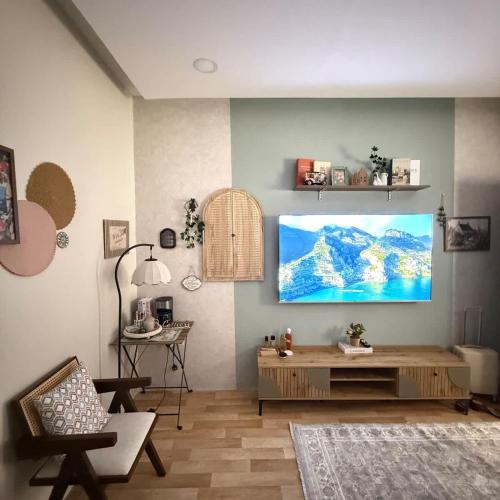 a living room with a flat screen tv on the wall at The Italian Studio3 in Dammam