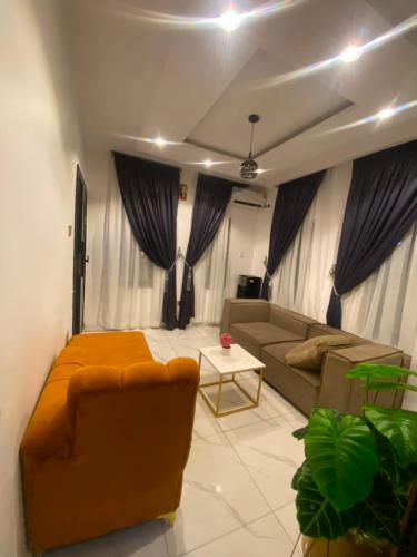 a living room with a couch and a table at whitestone palace hotel in Eggan
