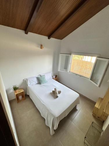 a bedroom with a bed with a teddy bear on it at Casa El Palmar - Playa y Jardín in El Palmar